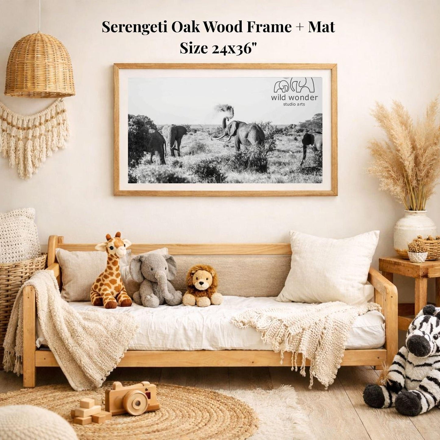 a cozy living room with a wooden frame and mat, a sofa with stuffed animals, and a large framed black and white photograph of elephants in the wild hanging on the wall.