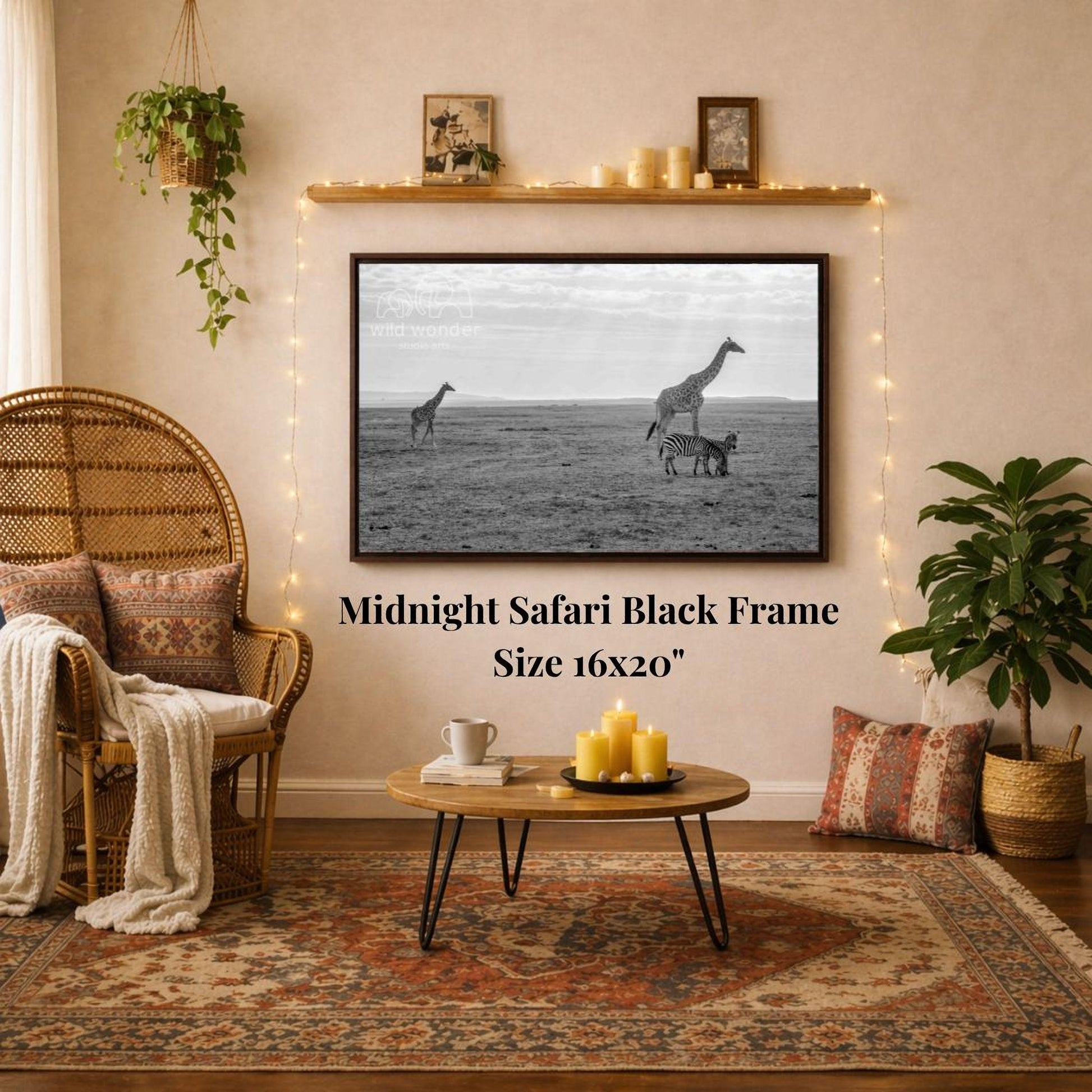 a living room with a large black frame hanging on the wall, depicting a scene of two giraffes in the wild. The room is decorated with a wicker chair, a coffee table, and a potted plant, creating a cozy and inviting atmosphere.