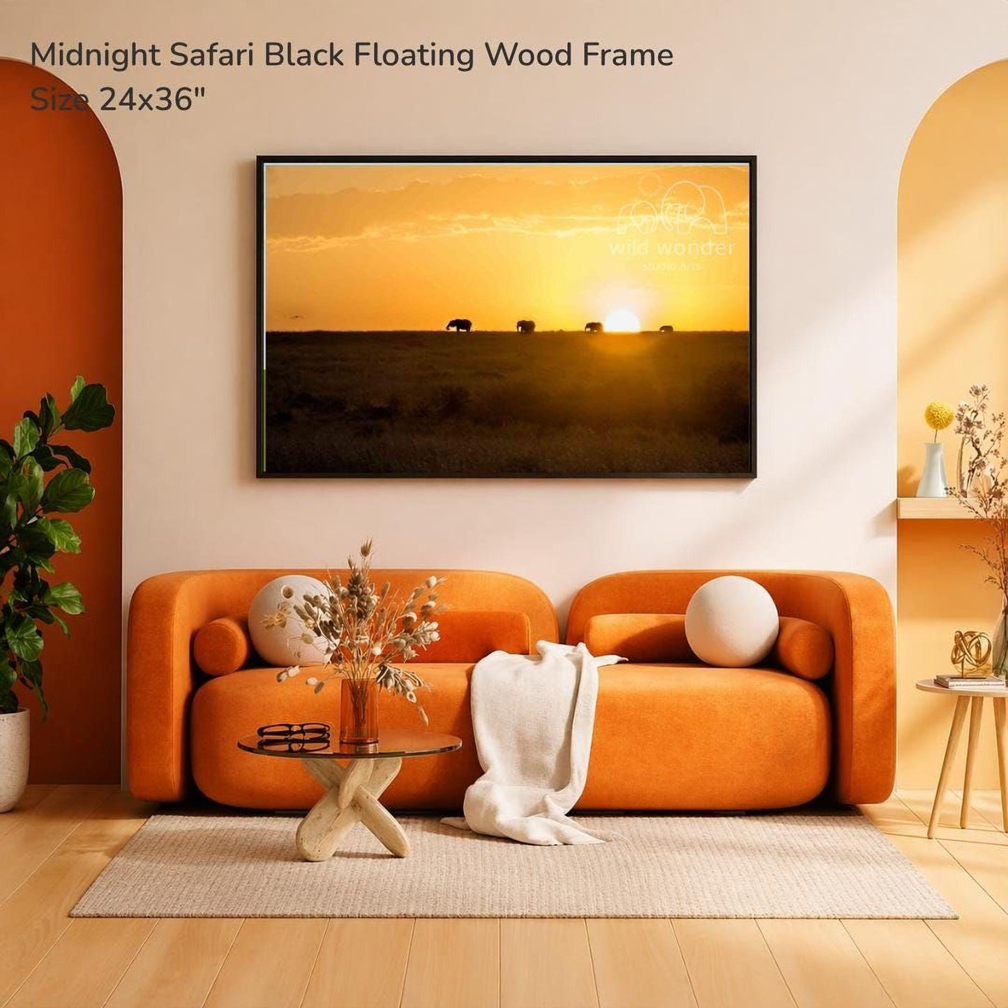 a modern living room with an orange sofa, a glass coffee table, and a framed photograph of a sunset over a savannah.