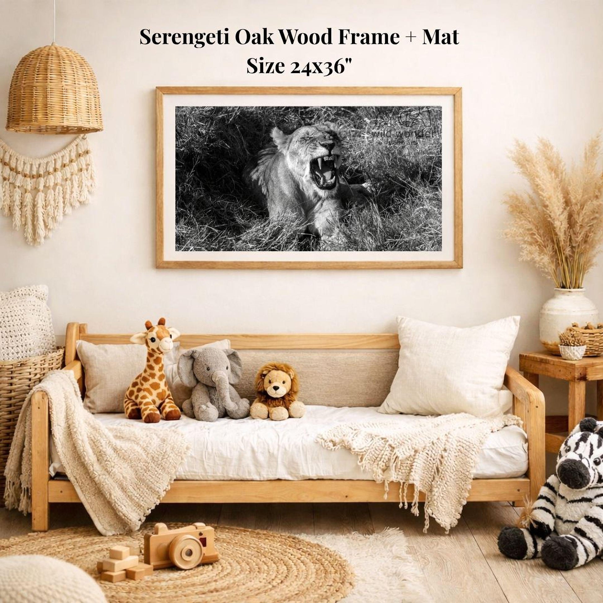 a serene indoor setting with a wooden frame and mat hanging on the wall, displaying a black and white photograph of a lion roaring in the wild. The frame is surrounded by various stuffed animals, including a giraffe, elephant, lion, and zebra, creating a cozy and playful atmosphere.