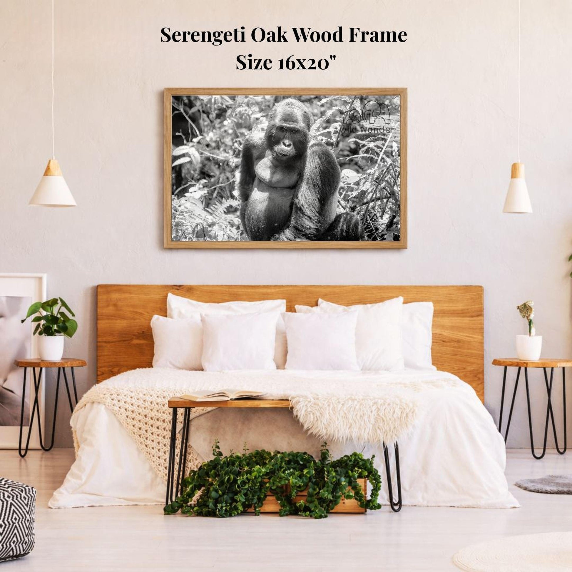 a serene bedroom scene with a large framed photograph of a gorilla hanging on the wall above a bed with white bedding.