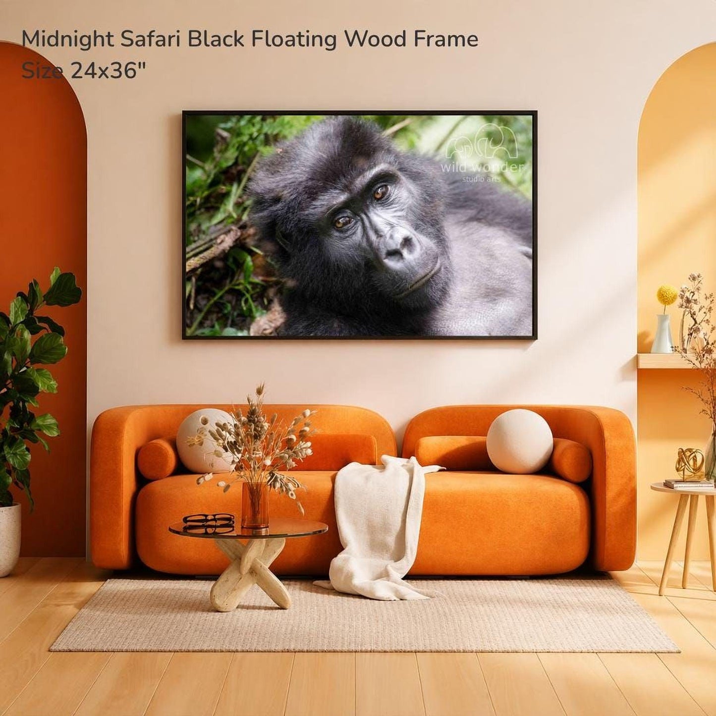 a large black floating wood frame with a close-up of a gorilla on it, hanging on a wall above an orange sofa in a living room.