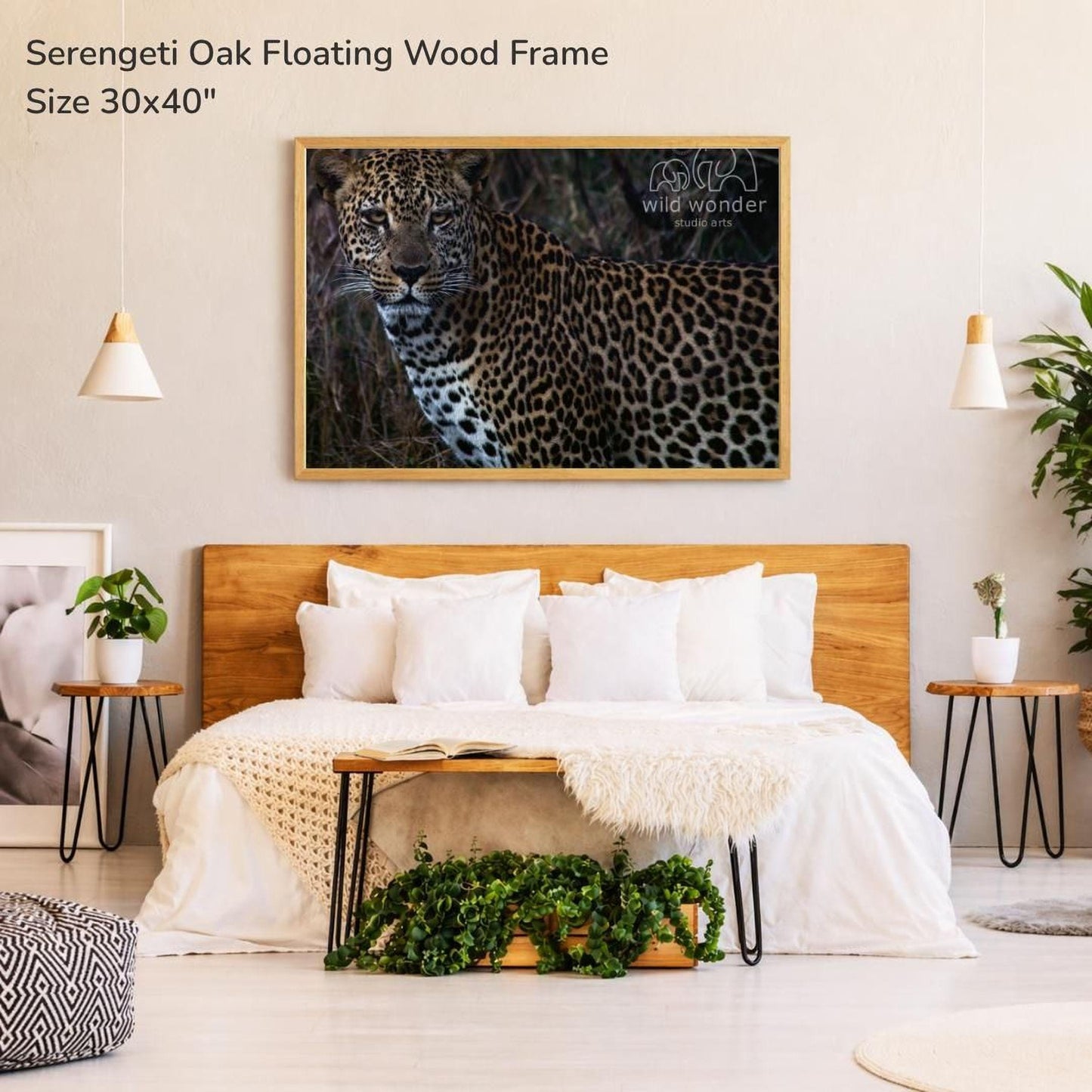 a bedroom with a large framed photograph of a leopard on the wall above a bed with white bedding.