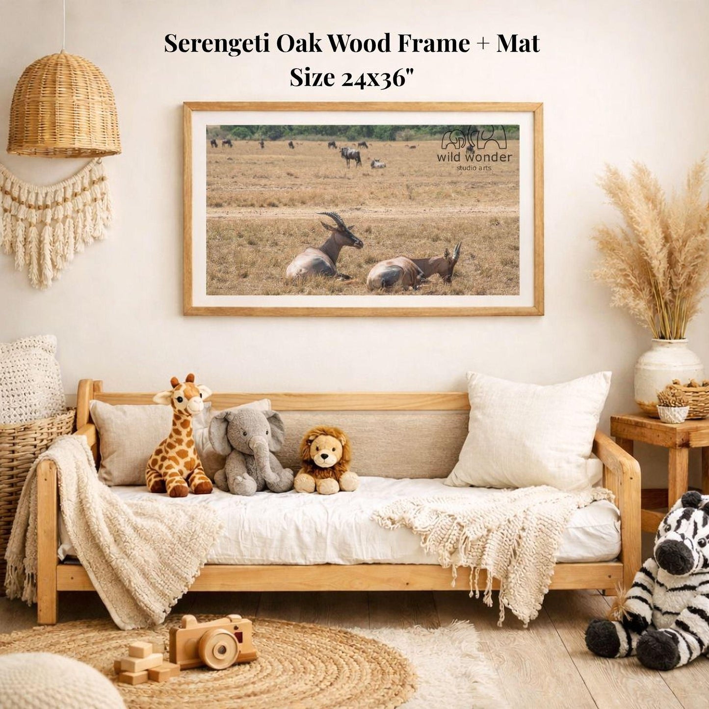a cozy living room with a wooden frame and mat hanging on the wall, displaying a photograph of a herd of wild animals in a field. The room is decorated with various items, including a wooden bench, a woven basket, a stuffed giraffe, a stuffed lion, and a stuffed zebra.