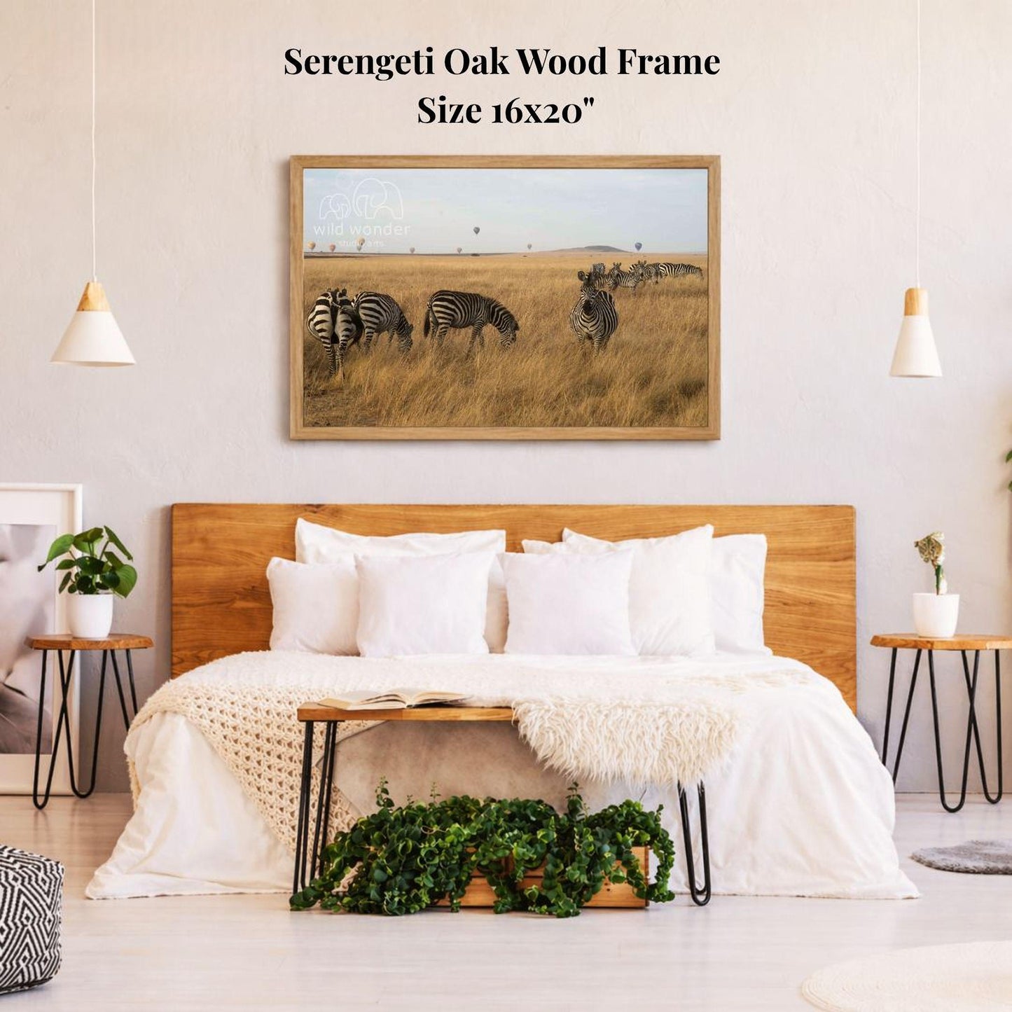 a serene bedroom scene with a large wooden headboard, a cozy bed with white pillows, and a framed photograph of zebras in a grassy field hanging on the wall above the bed.