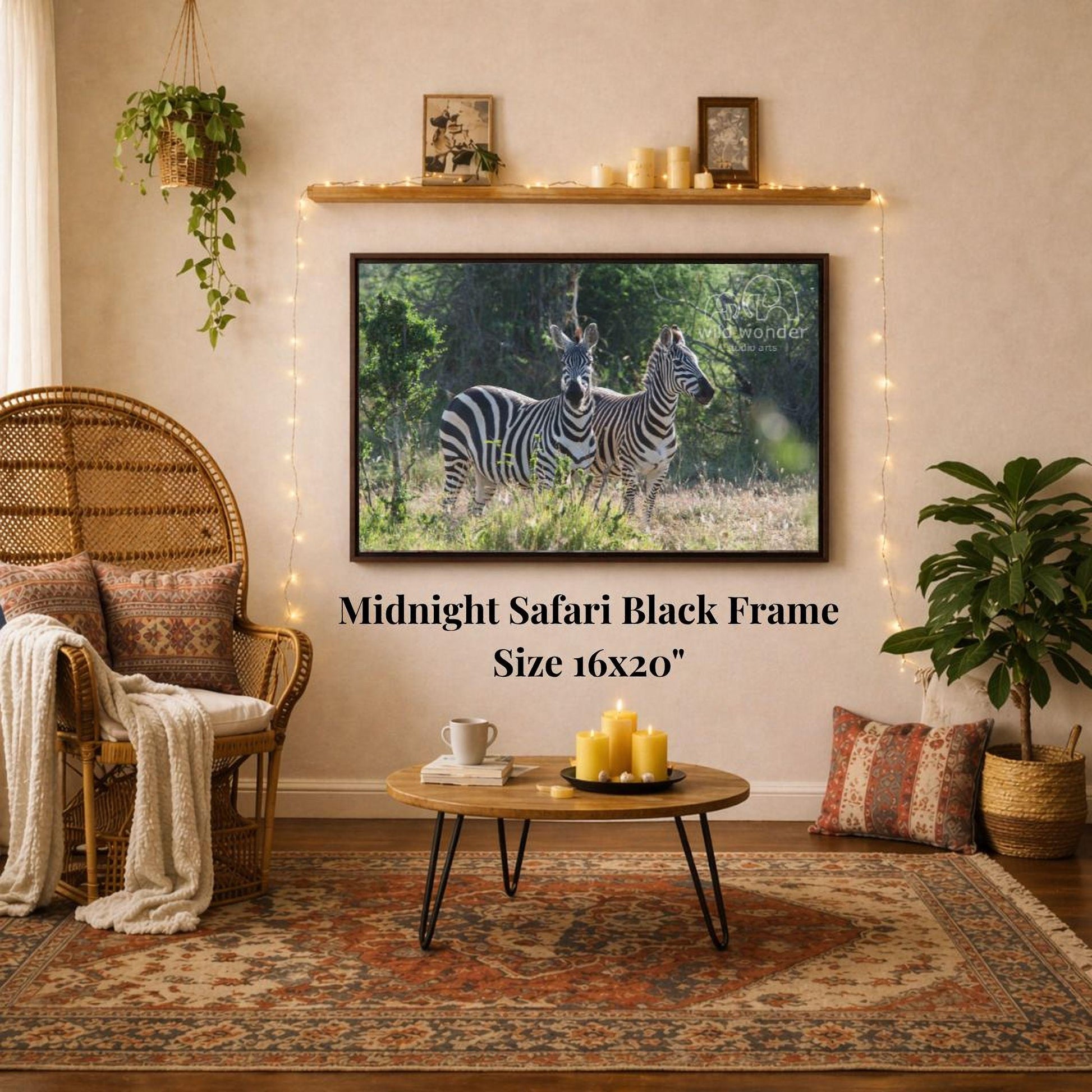 a living room with a large framed photograph of two zebras on the wall, a wicker chair, a coffee table, and a potted plant.