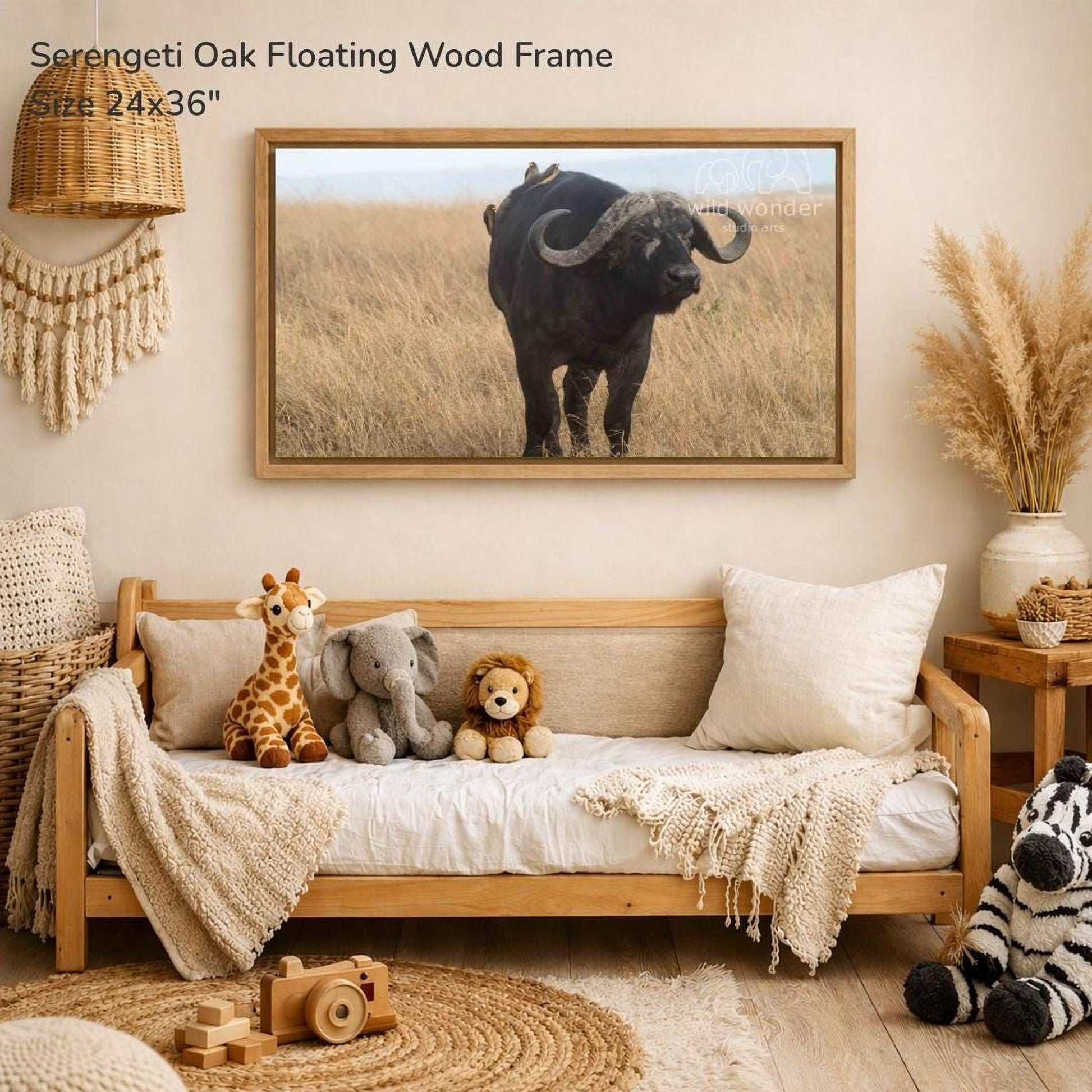 a serene indoor setting with a large framed photograph of a horned animal, likely a buffalo or ox, standing in a grassy field. The photograph is mounted on a wall above a wooden bench, which is adorned with stuffed animals, including a giraffe, an elephant, and a lion. The overall scene conveys a sense of tranquility and natural beauty.