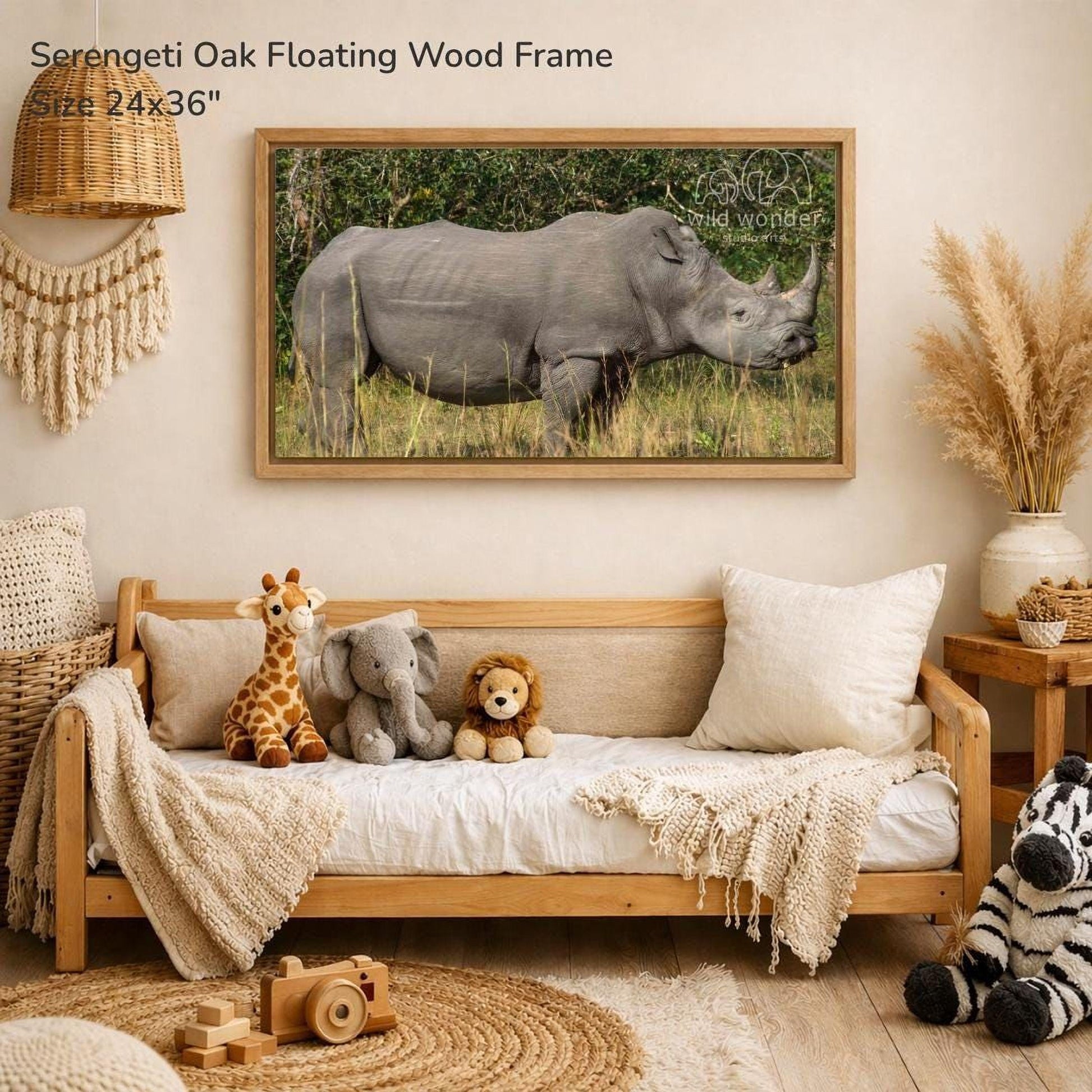 a serene indoor setting with a large framed photograph of a rhinoceros on the wall, surrounded by various stuffed animals and a wooden frame.