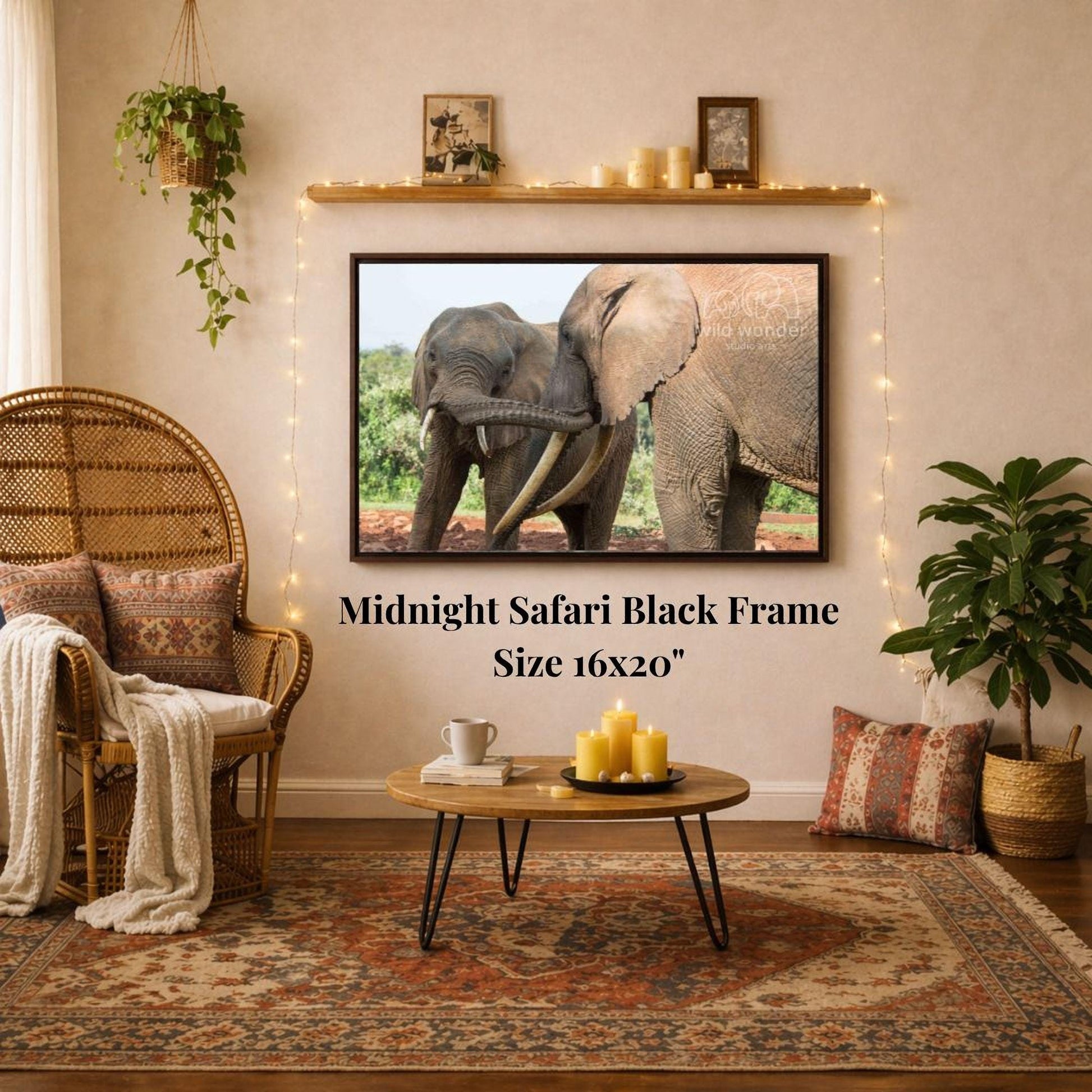 a living room with a large framed photograph of two elephants on the wall, a wicker chair, a coffee table, and a potted plant.