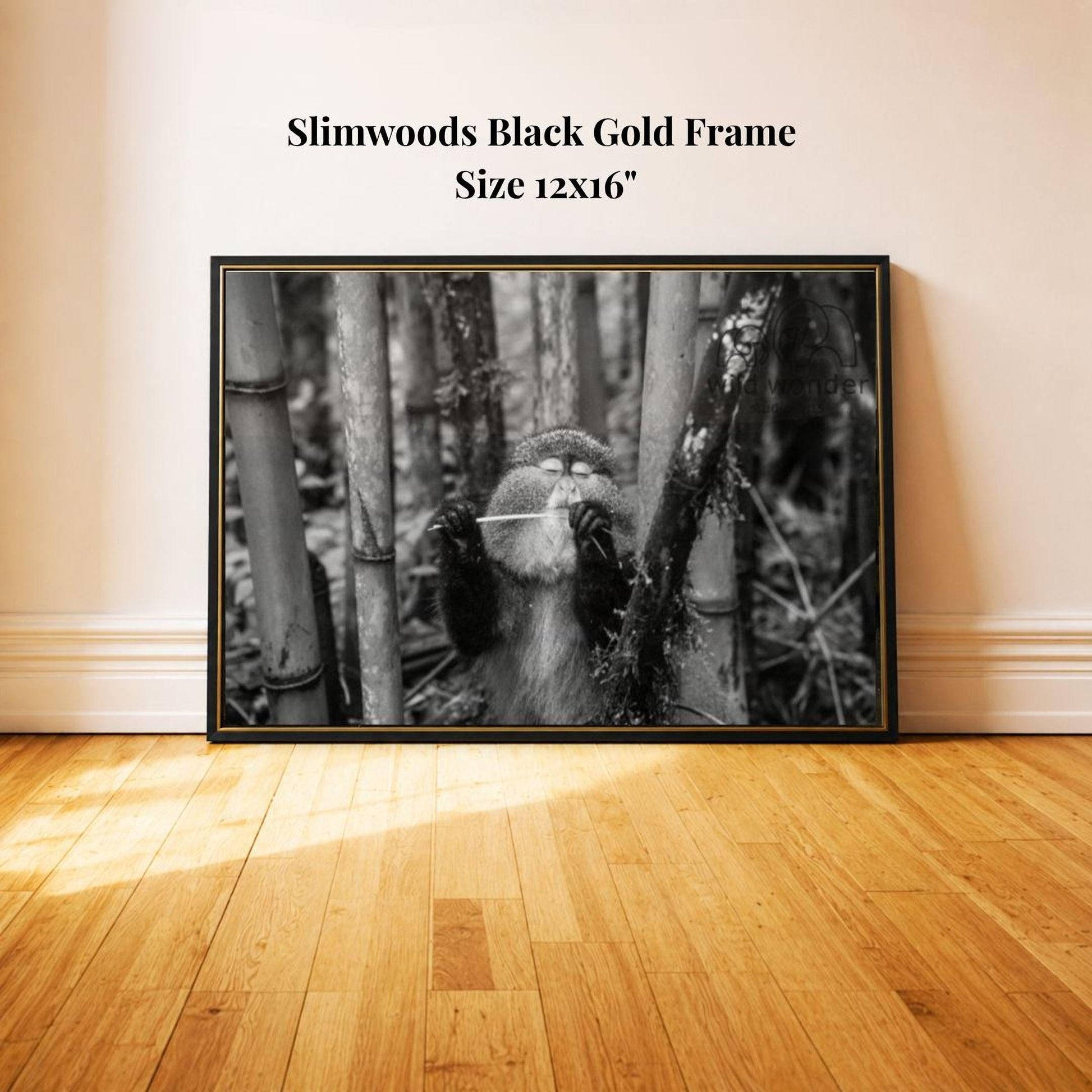 A black and white photograph of a monkey sitting on a tree branch in a forest setting.