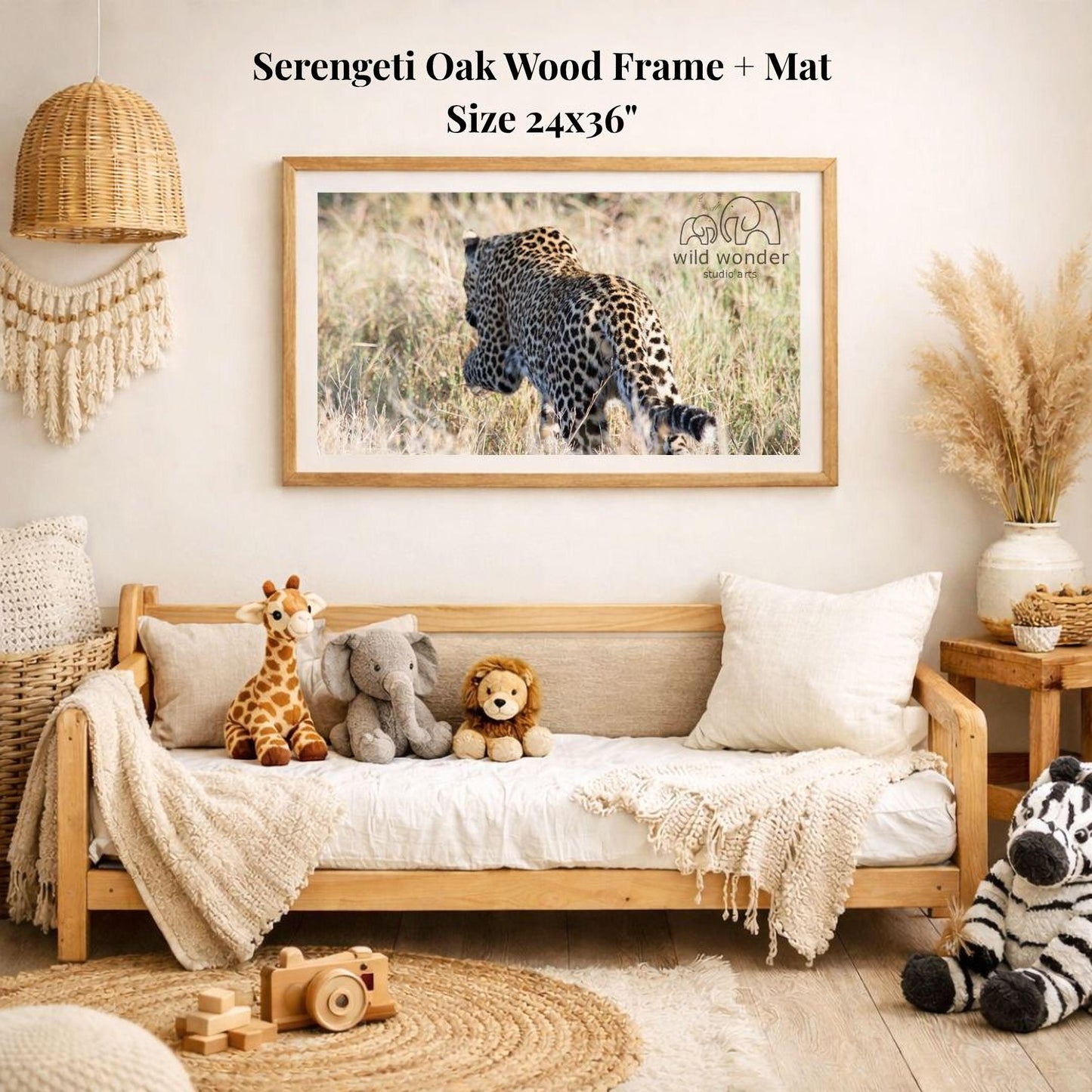 a serene indoor setting with a wooden frame and mat hanging on the wall, displaying a photograph of a leopard in the wild. The frame is surrounded by various stuffed animals, including a giraffe, an elephant, and a lion, creating a cozy and playful atmosphere.