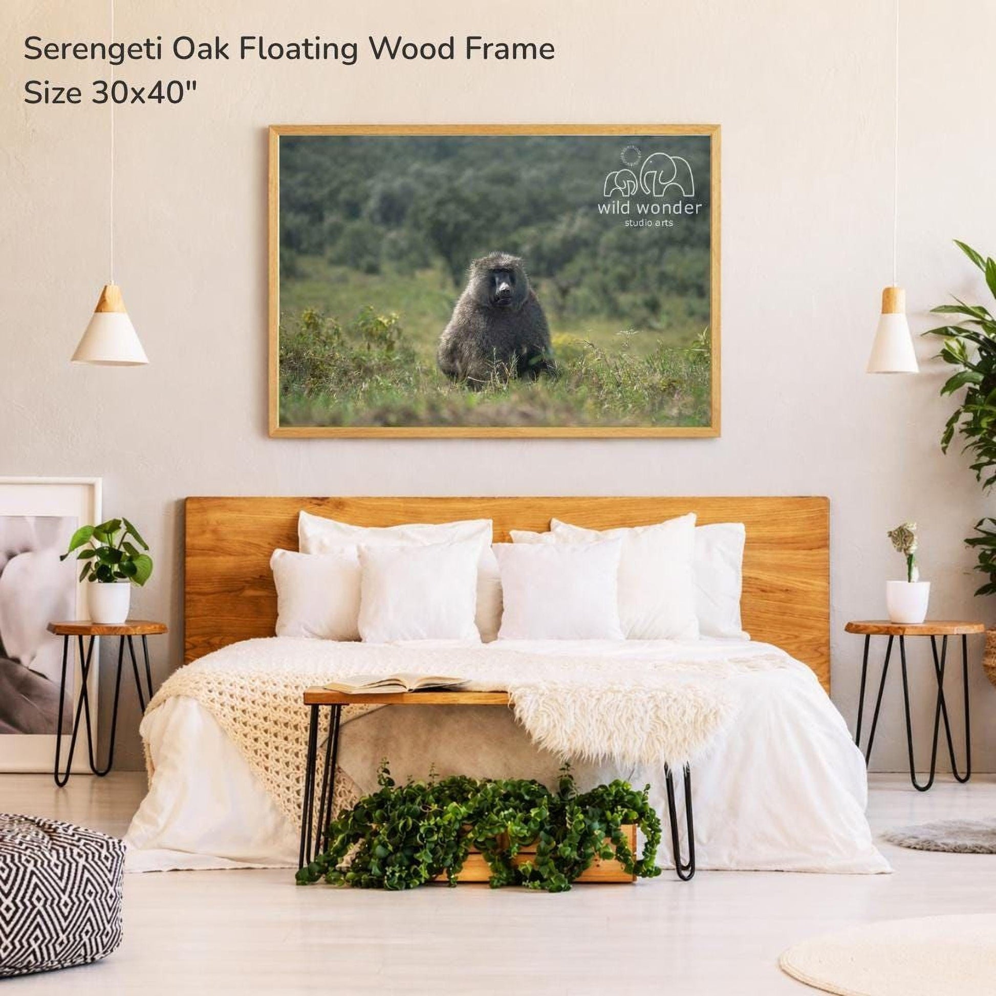 a serene bedroom setting with a large serenity oak floating wood frame hanging on the wall above a bed with white bedding.