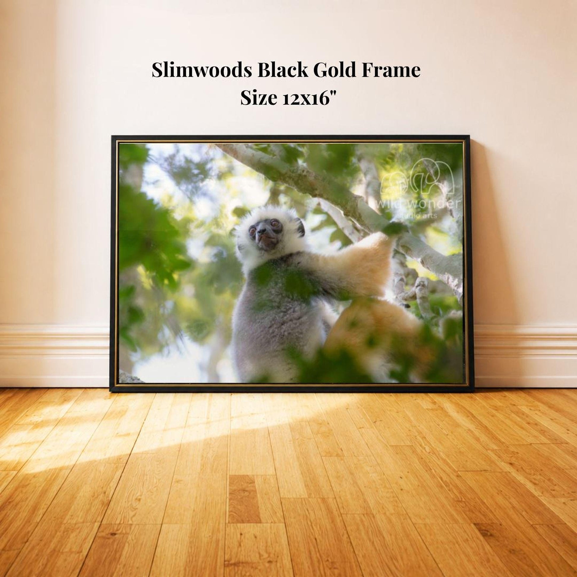 A framed photograph of a lemur, a type of primate, sitting on a tree branch in a lush, green environment.