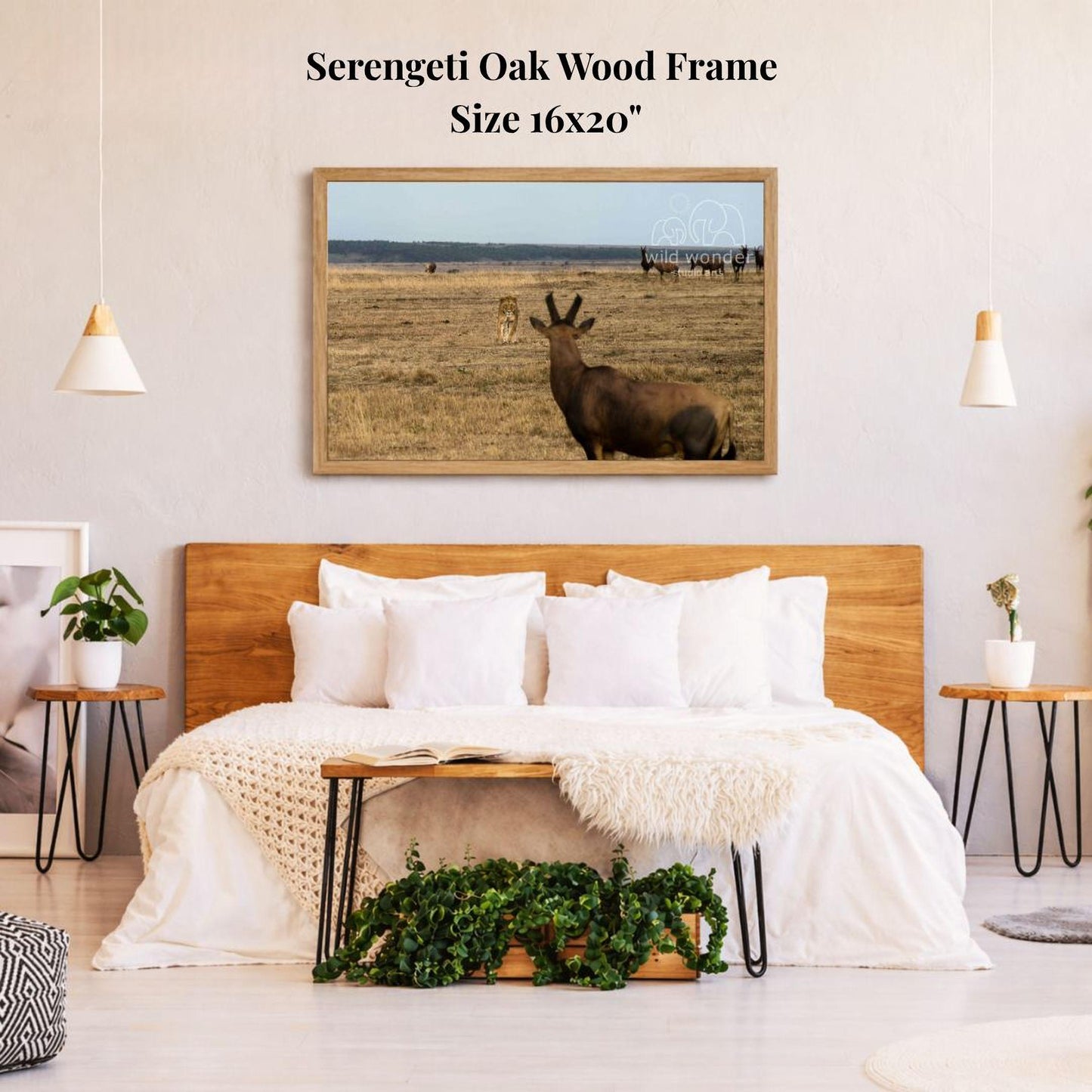 a serene bedroom scene with a large framed picture of a brown antelope in a field hanging on the wall above a bed with white bedding.
