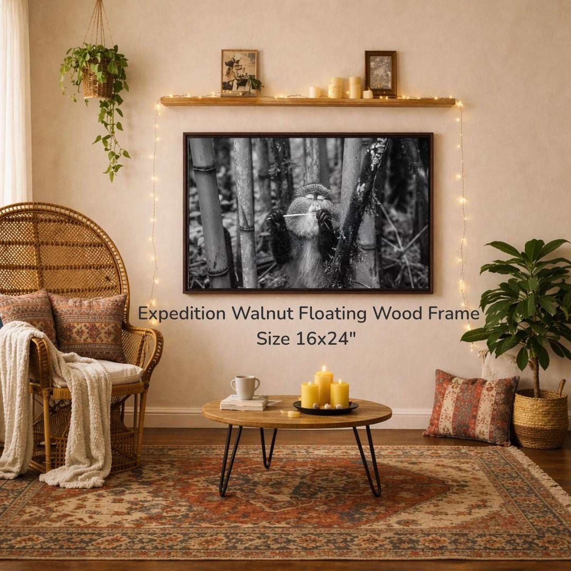 a cozy living room with a large 16x24" walnut floating wood frame hanging on the wall, a wicker chair, a coffee table with candles, and a potted plant.