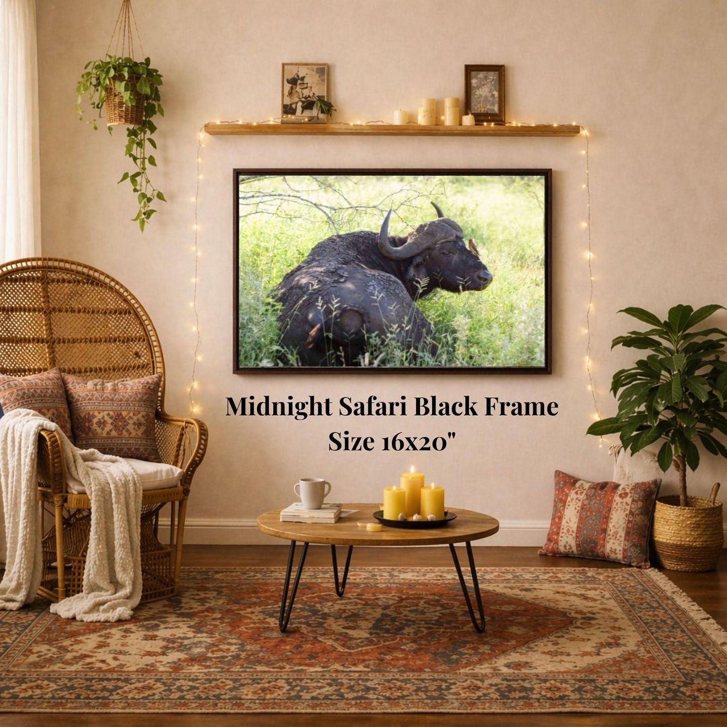 a living room with a large framed photograph of a black ox or buffalo on the wall, a wicker chair, a coffee table, and a potted plant.
