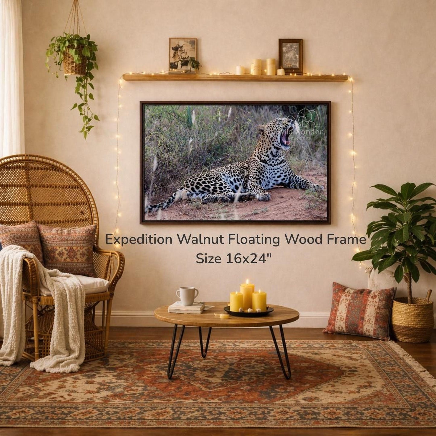 a large 16x24" walnut floating wood frame hanging on a wall, with a framed photograph of a leopard resting on the ground below it. The room has a cozy and rustic atmosphere, with a wicker chair, a coffee table, and various decorative elements such as plants and candles.