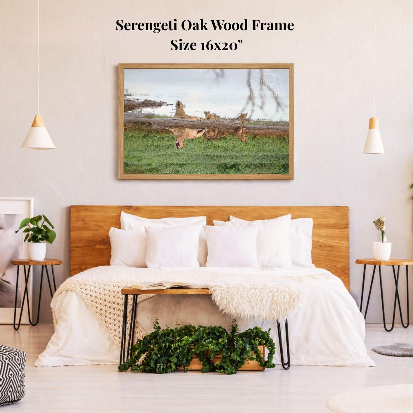 a serene bedroom setting with a large wooden headboard, a cozy bed with white bedding, and a framed picture of a serene landscape hanging above it.