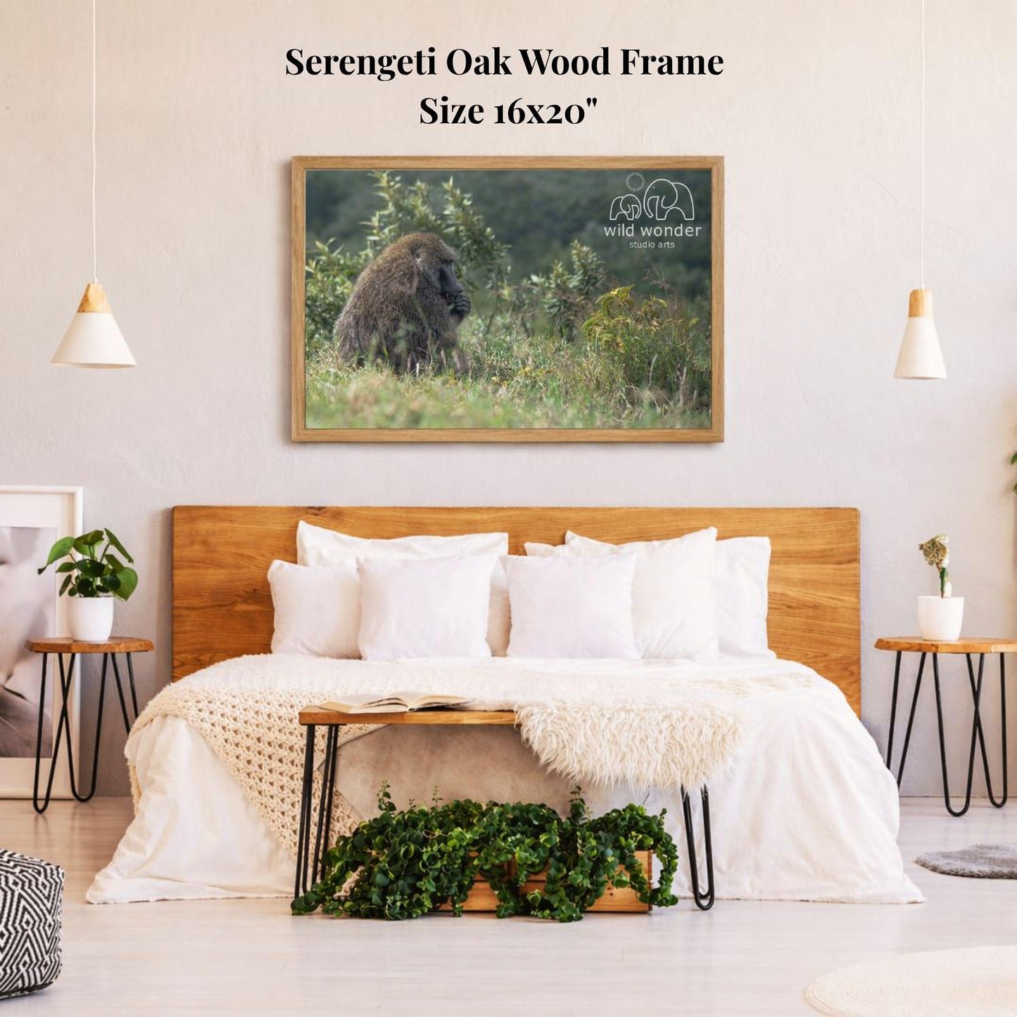 a serene bedroom setting with a large, 16x20" framed photograph of a gorilla sitting in the grass hanging on the wall above a bed with white bedding.