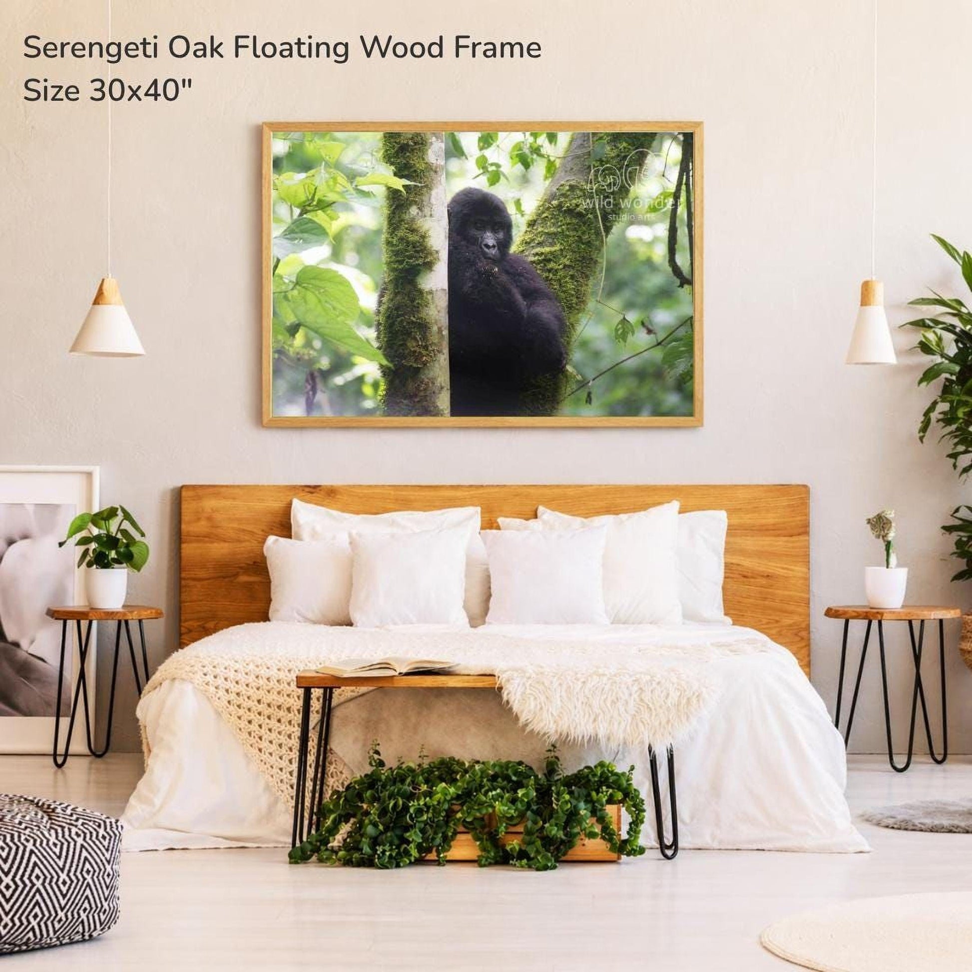 a serene bedroom setting with a large framed photograph of a gorilla perched on a tree branch hanging above a bed with white bedding.