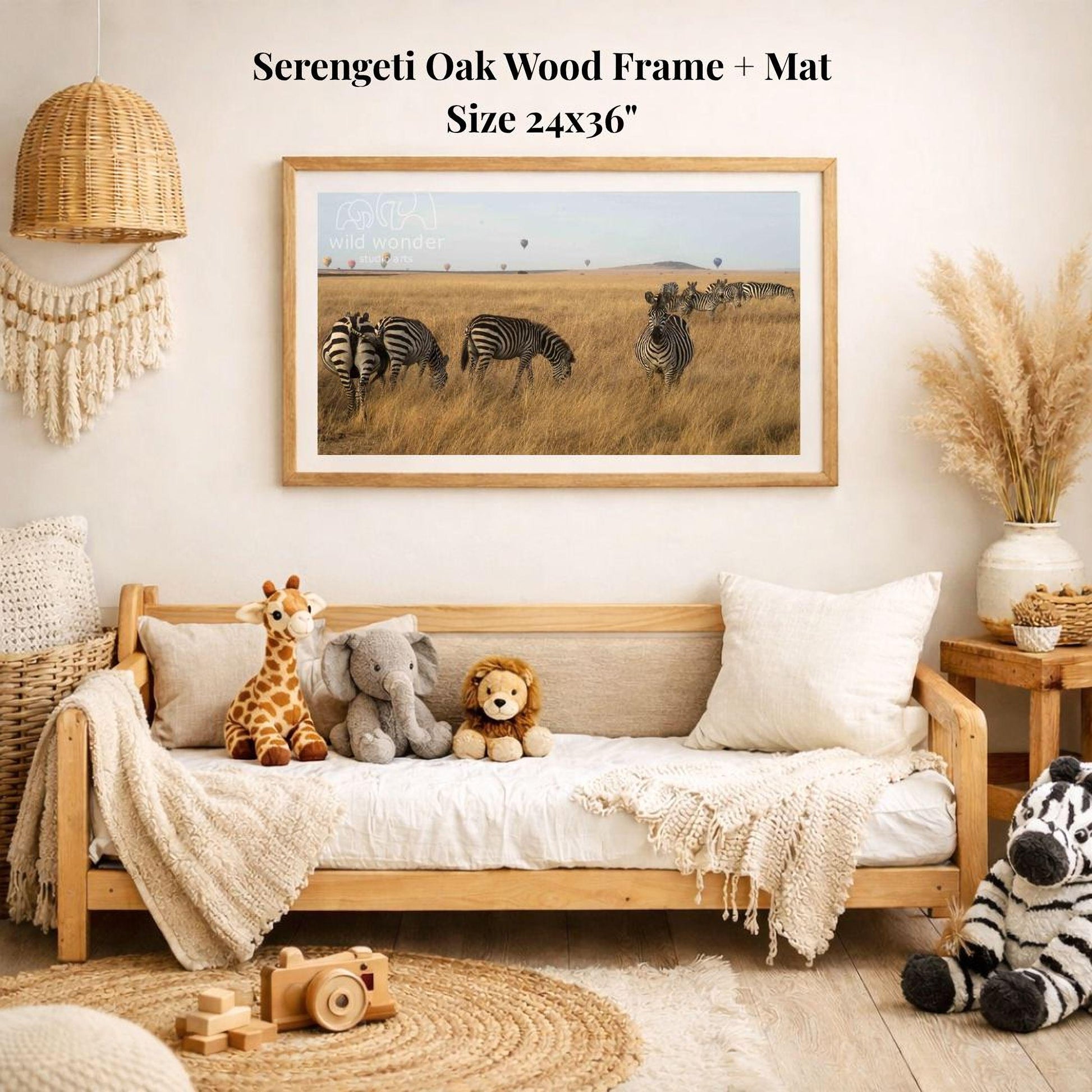 a serene indoor setting with a wooden frame and mat hanging on a wall, displaying a photograph of zebras in a grassy field. The room is decorated with various items, including a woven basket, a wooden chair, a stuffed giraffe, a stuffed lion, and a stuffed zebra.