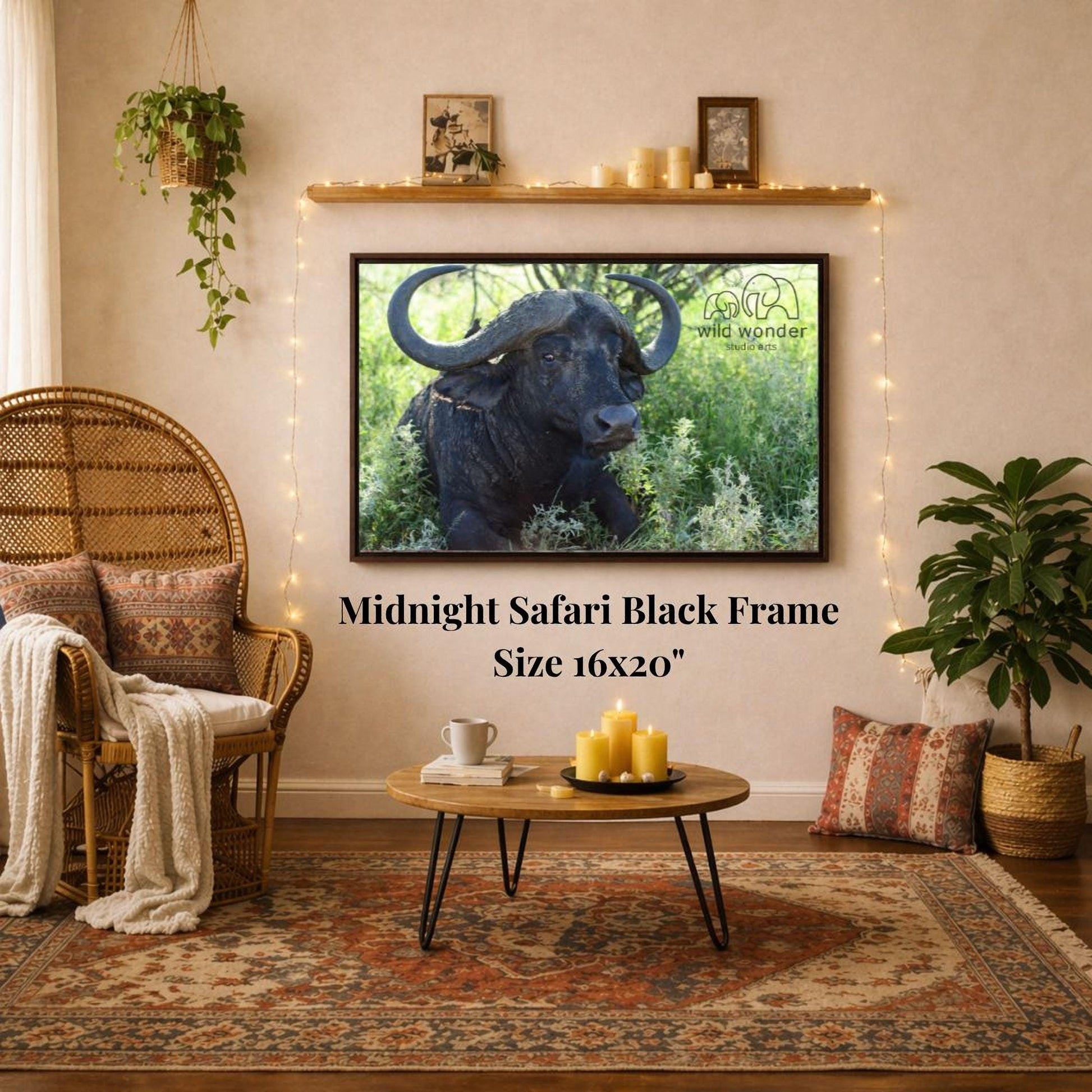 a living room with a large framed photograph of a black ox or buffalo on the wall, a wicker chair, a coffee table, and a potted plant.