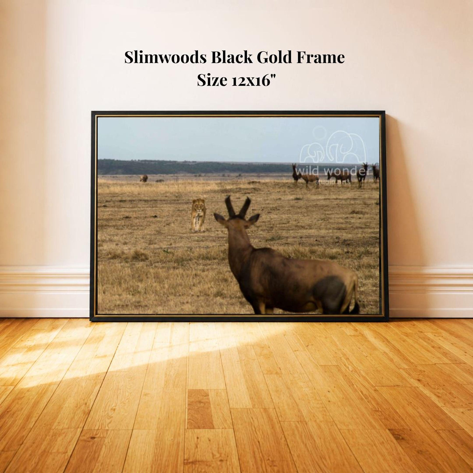 a black gold frame with a photograph of a wild animal, likely a deer or antelope, in a grassy field.