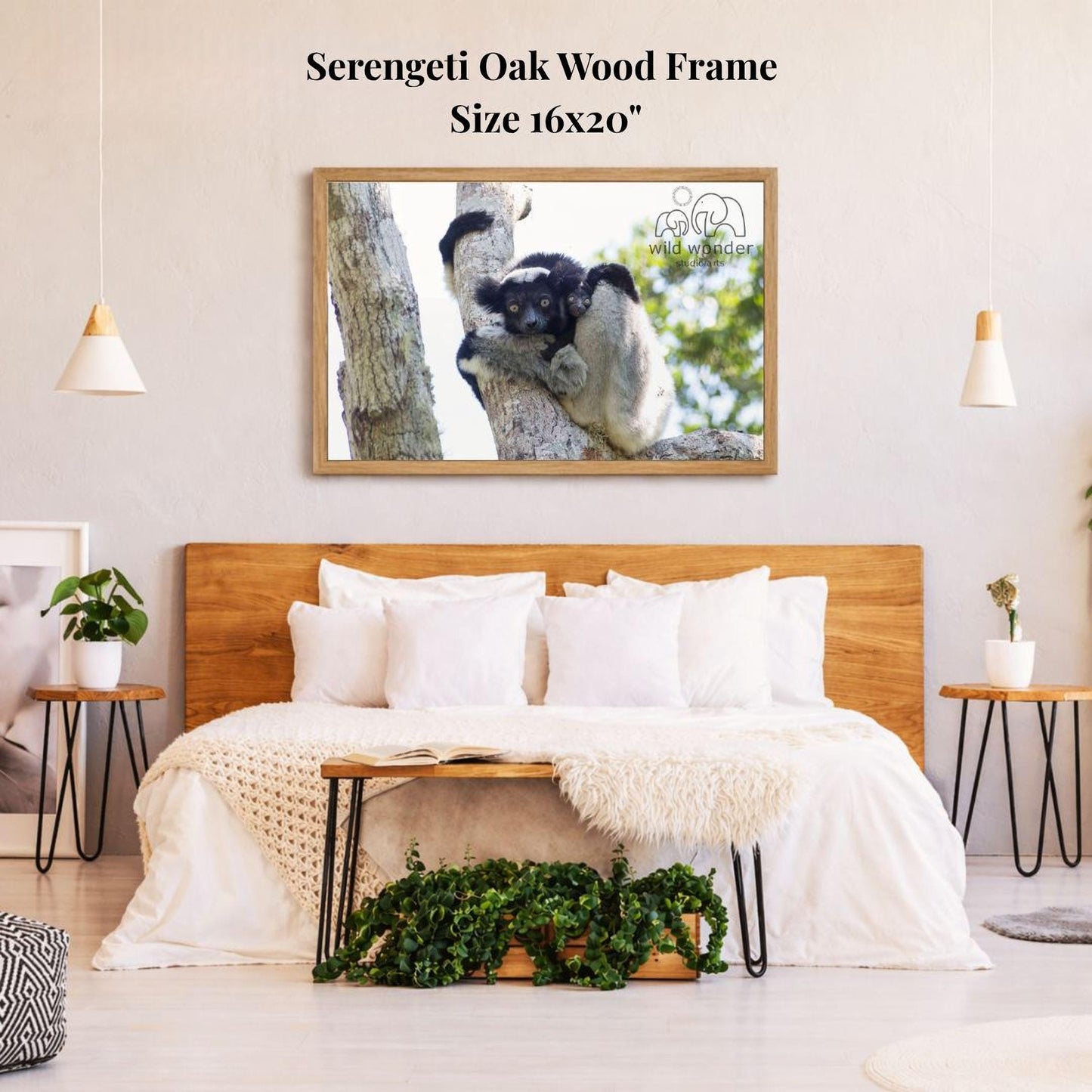 a serene bedroom setting with a large, 16x20" framed photograph of a sleeping animal, likely a cat or a small mammal, hanging on the wall above a bed with white bedding. The room has a wooden headboard and a wooden nightstand on each side of the bed, with a potted plant and a small plant on the nightstands. The overall atmosphere of the room is calm and cozy, with a focus on the natural elements and the peaceful scene captured in the photograph.