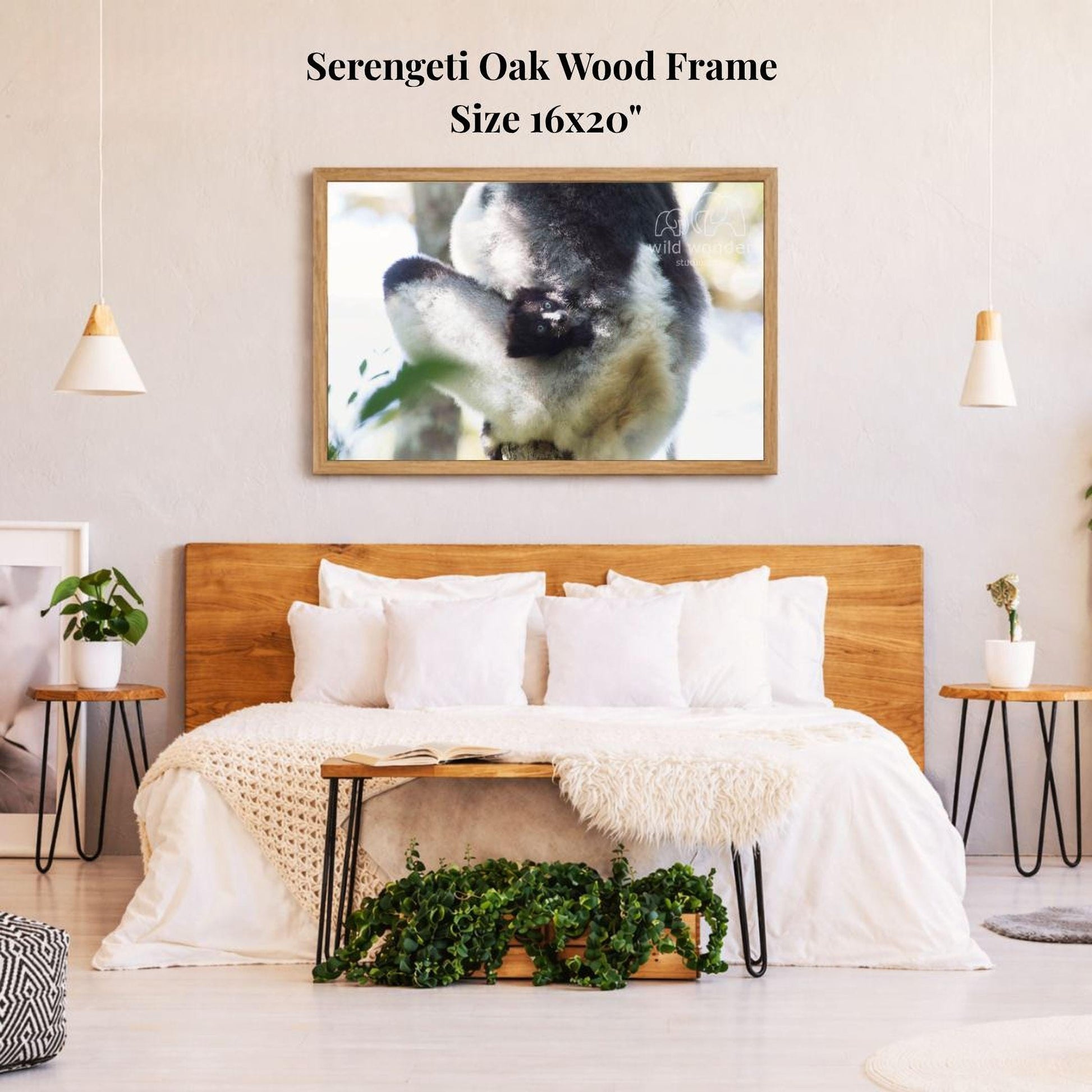 a serene bedroom setting with a large, 16x20" framed photograph of a sleeping dog hanging on the wall above a bed with white bedding.