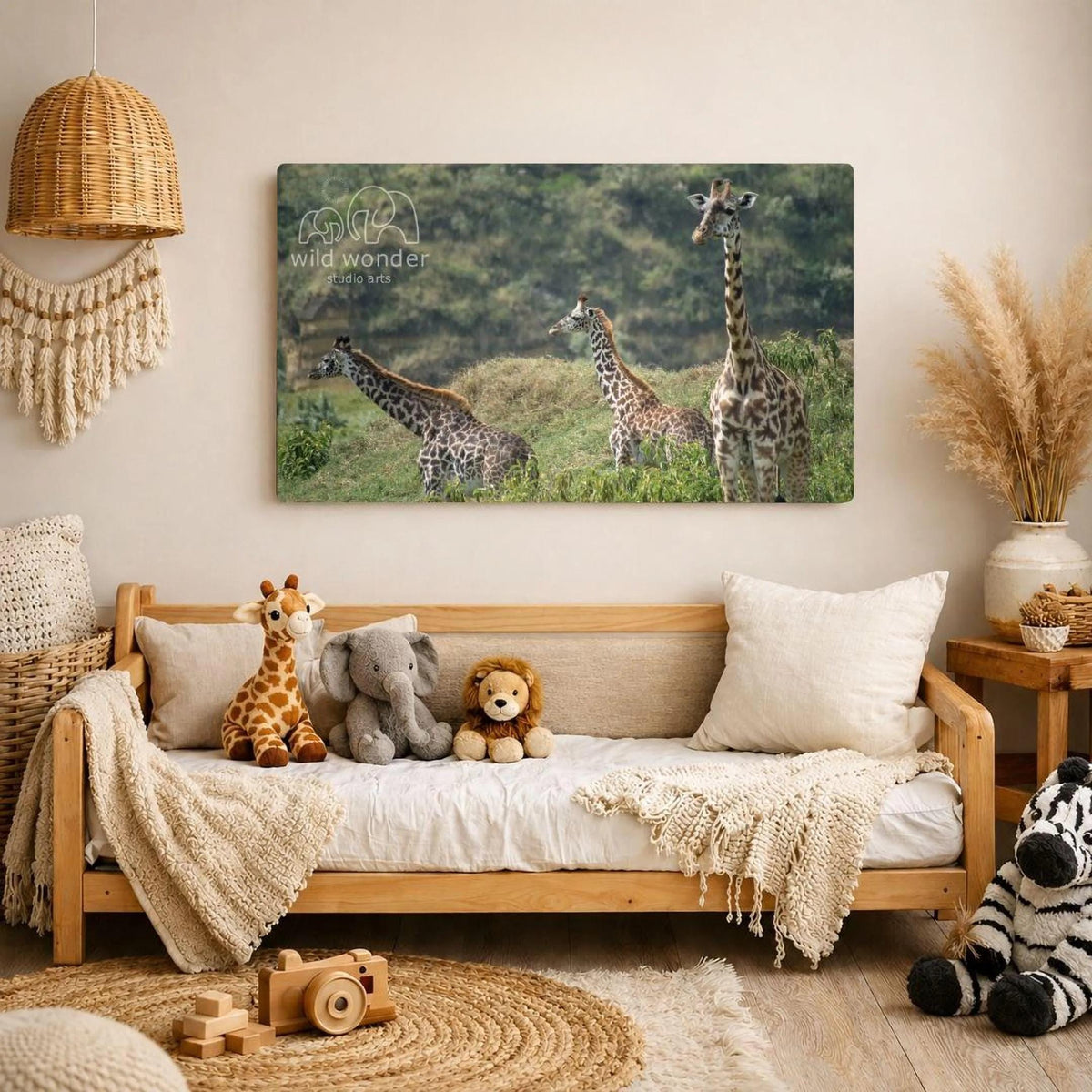 a cozy living room with a large metal print of a group of giraffes in a grassy field hanging on the wall. The print is 24x36 inches in size. The room is decorated with various items, including a woven basket, a wooden chair, a stuffed lion, and a stuffed zebra. The overall atmosphere of the room is warm and inviting, with the giraffe print serving as a focal point.