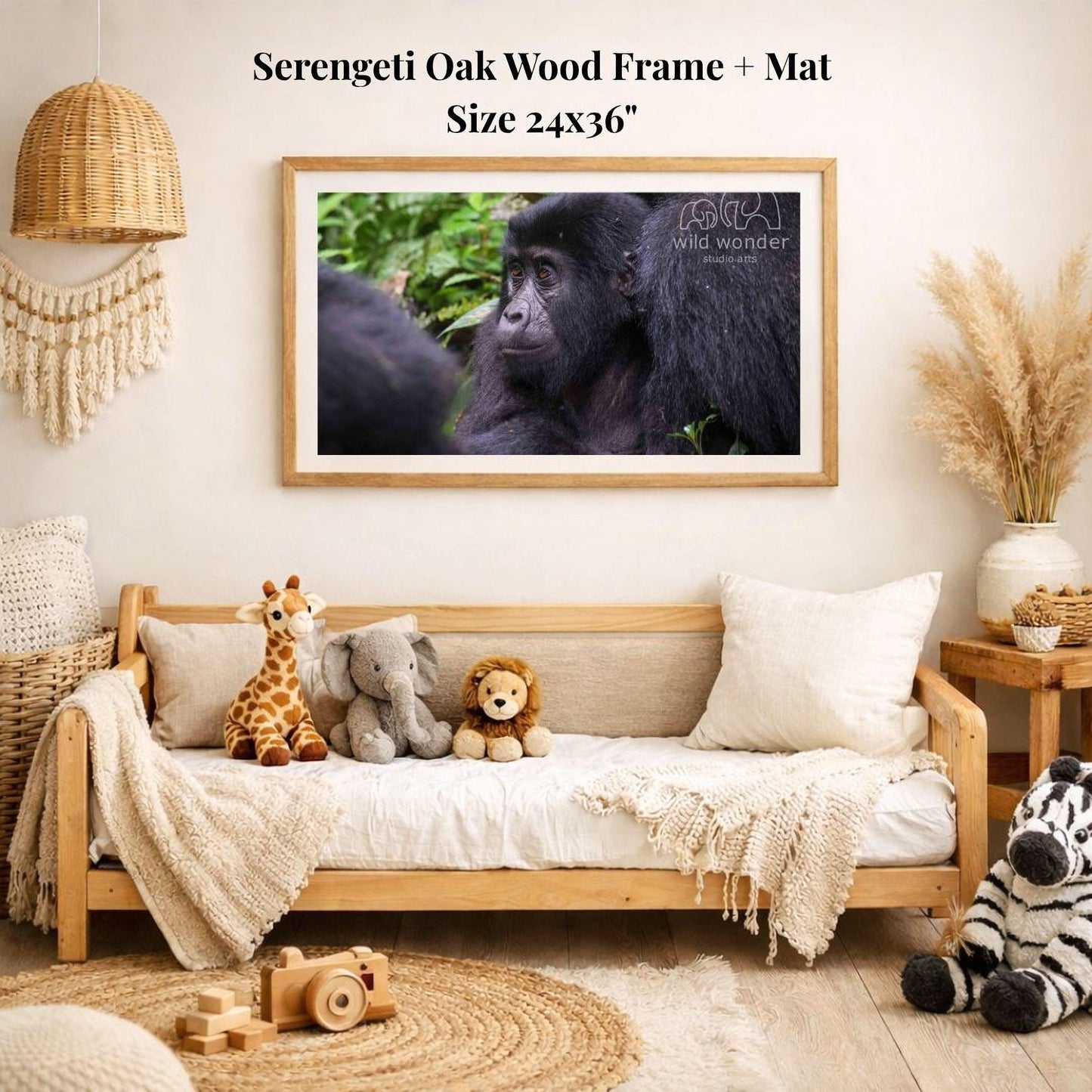 a serene indoor setting with a wooden frame and mat hanging on a wall, displaying a photograph of two black gorillas in their natural habitat. The room is decorated with various stuffed animals, including a giraffe, elephant, lion, and zebra, arranged on a couch and a bed. A wooden toy camera is also present in the scene.