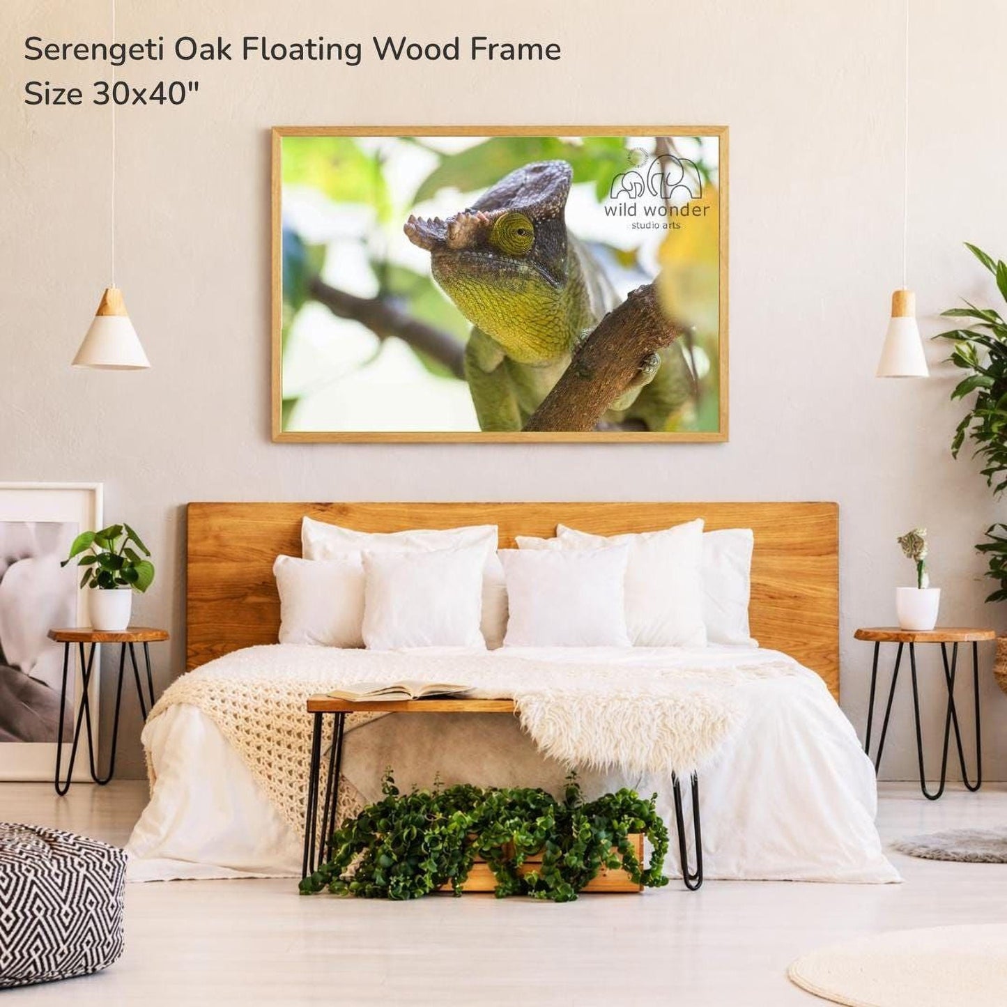 a bedroom with a large framed photograph of a chameleon on the wall above a bed with white bedding.