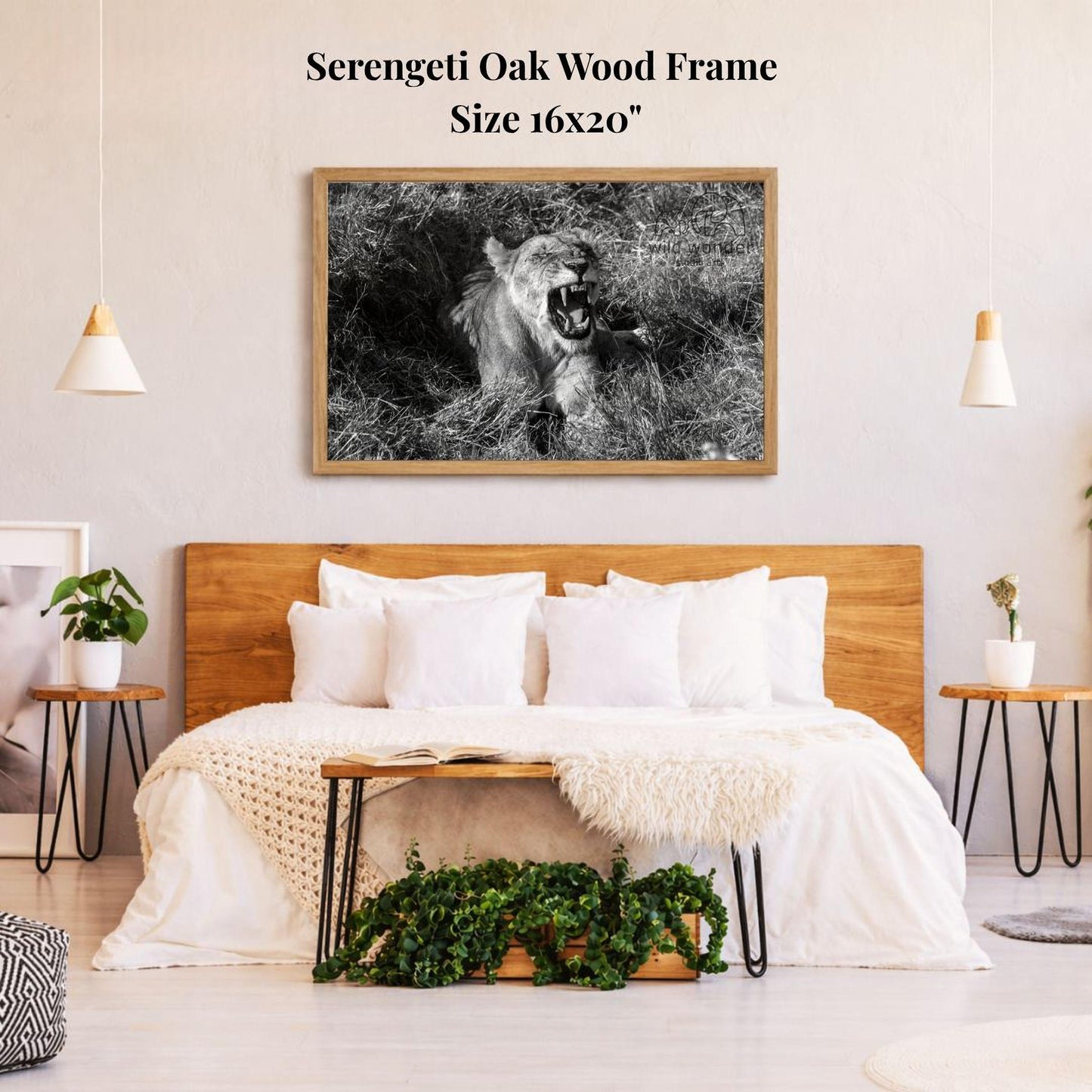 a bedroom with a large wooden headboard and a framed black and white photograph of a lion on the wall above it. The room has a minimalist and modern design, with a white bedding set, a wooden nightstand, and a potted plant on the floor.