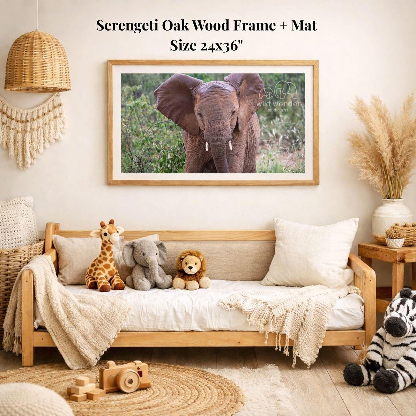 a serene indoor setting with a wooden frame and mat hanging on the wall, displaying a photograph of an elephant. The room is decorated with various stuffed animals, including a giraffe, lion, and zebra, arranged on a couch and a bed. A wooden toy camera is also present in the scene.
