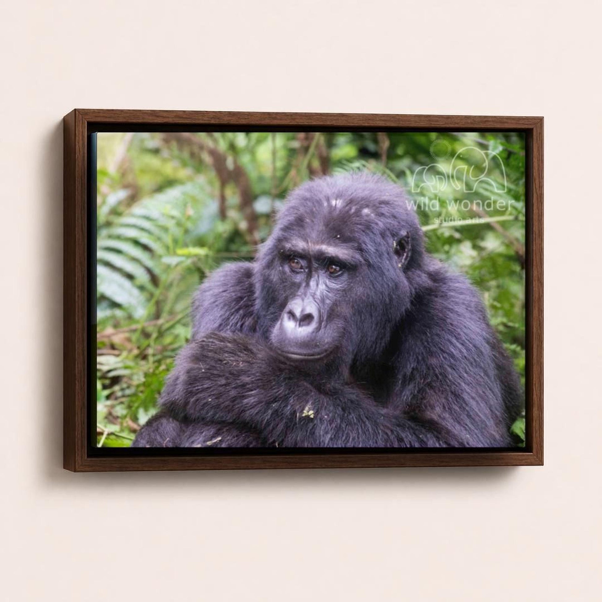 A close-up portrait of a gorilla sitting in a lush, green forest environment.